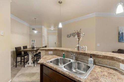 a kitchen with a sink and a dining room at Lovely 1-bedroom apartment w/ Pool + Wi-Fi in Charlotte