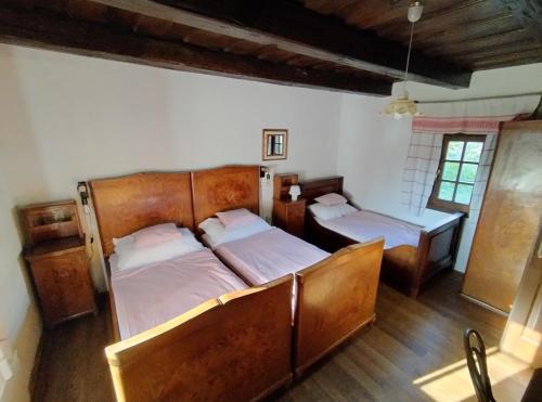 a bedroom with two beds in a room at Őrségi Porta in Magyarszombatfa