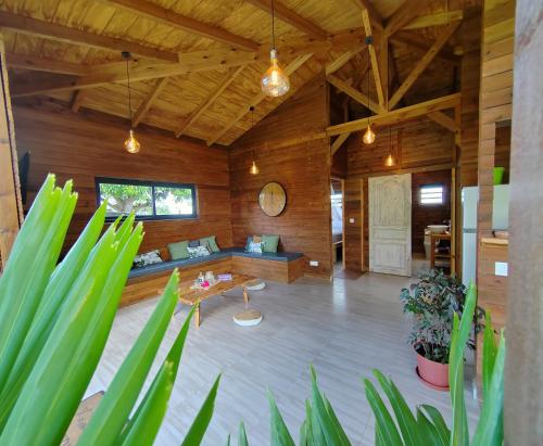 a living room with a couch and a table at Odyssea Caraïbes Cottages & Spa in Saint-Louis