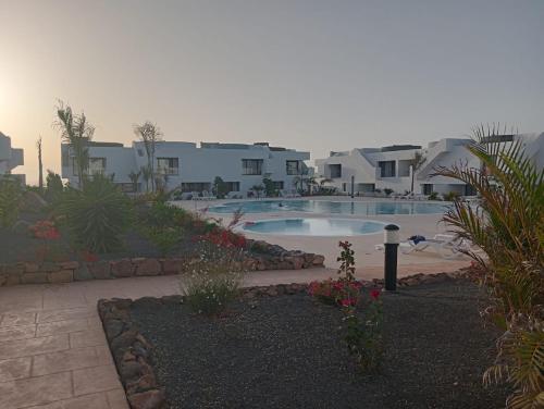 a resort with a swimming pool and some buildings at Aulaga in Villaverde