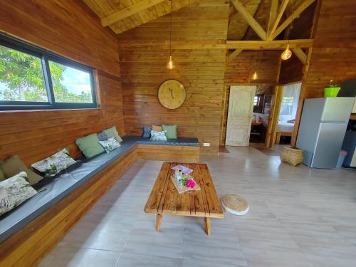 a living room with a couch and a table at Odyssea Caraïbes Cottages & Spa in Saint-Louis
