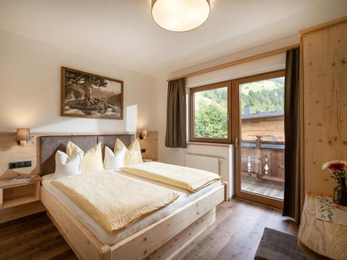 a bedroom with a large bed and a window at Landhaus Christina in Brandberg