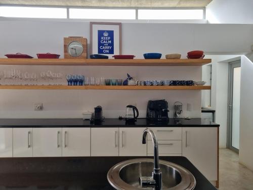 a kitchen with a sink and a counter top at Henties Bay Haven Holiday Home in Hentiesbaai