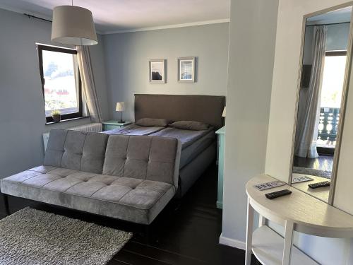 a living room with a bed and a couch at Bergbach in Ramsau