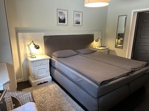 a bedroom with a large bed and two night stands at Bergbach in Ramsau