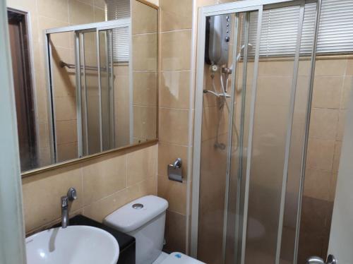 a bathroom with a shower and a toilet and a sink at Dream East Lake in Seri Kembangan