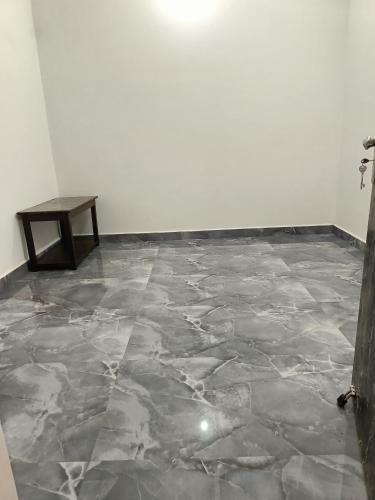 a room with a marble floor and a table at Shree Yamunaji Kripa Kunj in Gokul