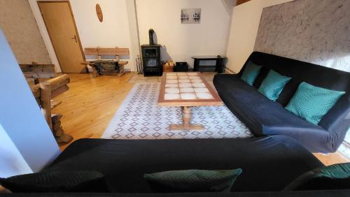 a living room with a couch and a table at Cozy Cottage Vlašić in Vlasic
