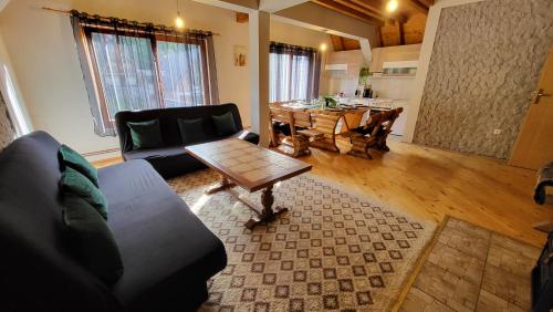 a living room with a couch and a table at Cozy Cottage Vlašić in Vlasic