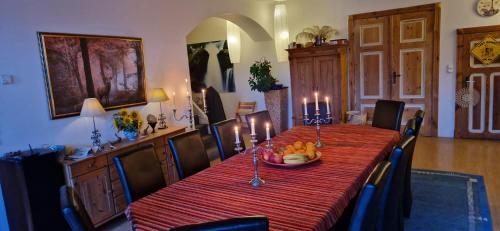a dining room with a table with candles on it at Gutshaus Pinnow in Pinnow