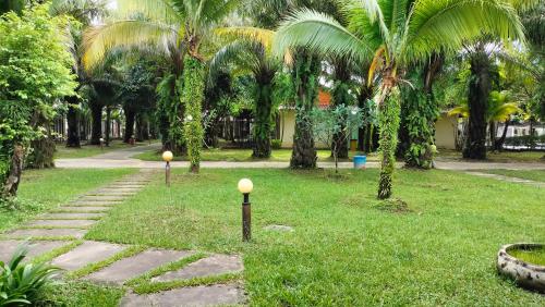 a park with palm trees and a walkway at Twin Palms Resort in Sihanoukville