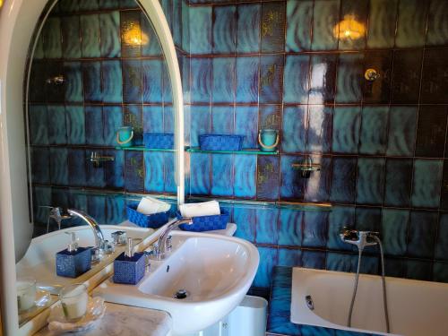 a bathroom with a sink and a tub and a mirror at Antica Terrazza in Terni