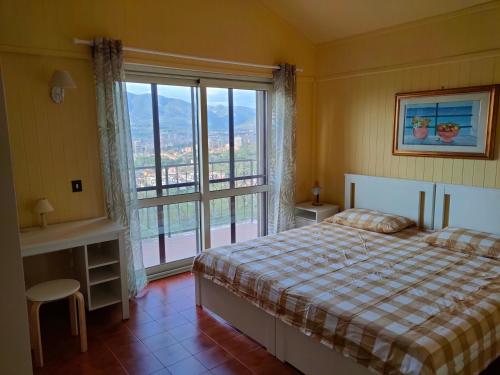 ein Schlafzimmer mit einem Bett und einem großen Fenster in der Unterkunft Antica Terrazza in Terni