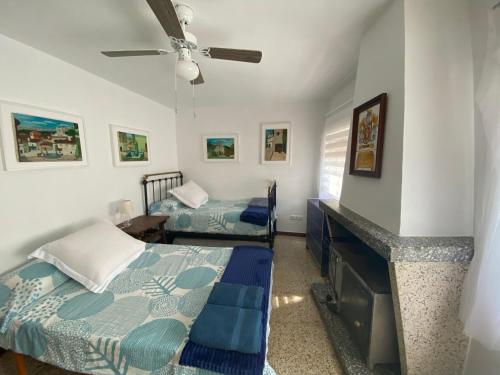 a bedroom with two beds and a fireplace at Arenalita in El Arenal