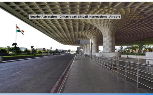 an airport terminal with an empty road and a large roof at Hotel Golden Arch - NEAR DOMESTIC AIRPORT in Mumbai