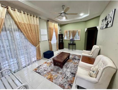 a living room with a couch and a table at Daffodil Homestay in Perlis in Kangar