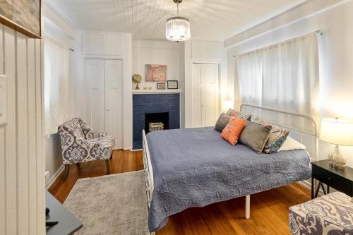 a bedroom with a bed and a couch and a fireplace at Home - Elegant comfort 22 minutes to OSU in Lebanon