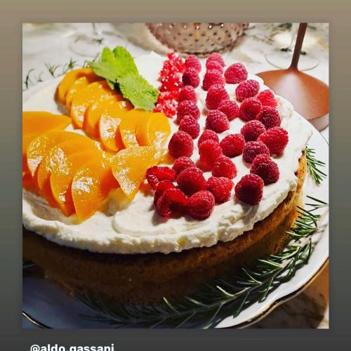 a cake with fruit on top of it on a plate at Tenuta Zamparina in Montignoso
