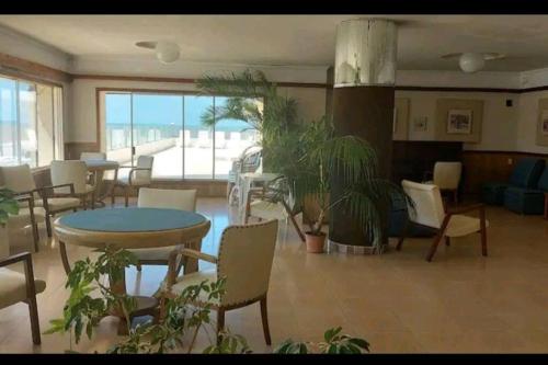 a living room with plants and a table and chairs at Edificio Punta del Este in Punta del Este