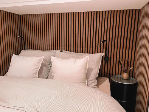 a bedroom with a bed with white sheets and pillows at Coolest Apartments in Haarlem City - close to Beach and Amsterdam in Haarlem