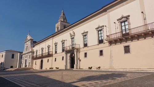 a large white building with a tower on top of it at ll Covo del Brigante in Melfi