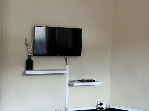 a flat screen tv hanging on a white wall at Summerstrand holiday home in Summerstrand