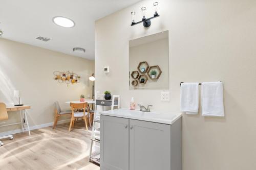 a white bathroom with a sink and a table at 1 Bedroom Apt near Santana Row, recently remodeled in San Jose