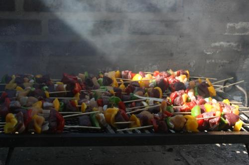 a bunch of vegetables cooking on a grill at Finca La Celestita in Colonia Alvear