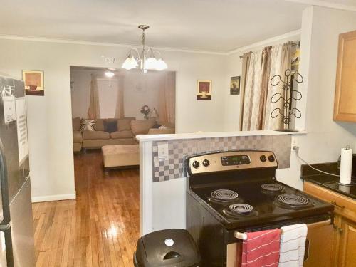 a kitchen with a stove and a living room at Decatur Dream in Decatur