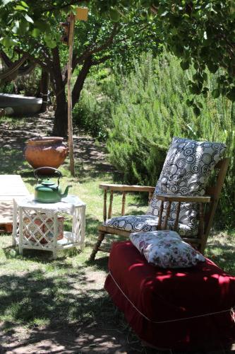 a chair and a ottoman sitting next to a table at Finca La Celestita in Colonia Alvear