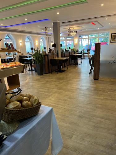 a lobby with a table with a basket of bread at Hotel Seewiefken in Wangerland