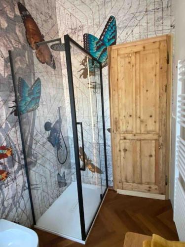 a room with butterflies on the wall and a door at Olivietta Suite in Cervia