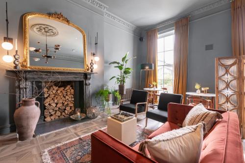 a living room with a fireplace and a mirror at Number 59 - Irish Stay Group in Dublin