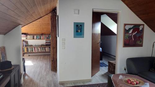 a living room with a couch and a room with a book shelf at Úlehla House in Zlín