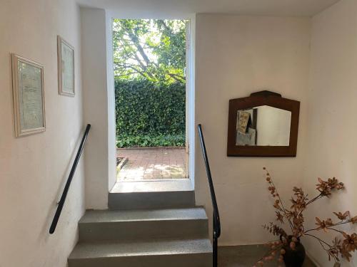 a stairway with a window and a stair case at Historisch Pand in Spechtholzhock