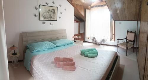 a bedroom with a bed with two pillows on it at Casa Reale in Gravina di Catania