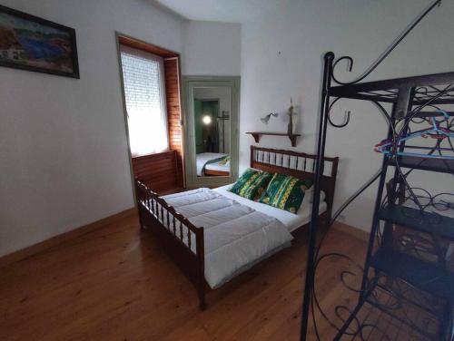 a bedroom with a bed and a ladder in a room at Le Nid Douillet Bohème Linge fourni in La Bourboule