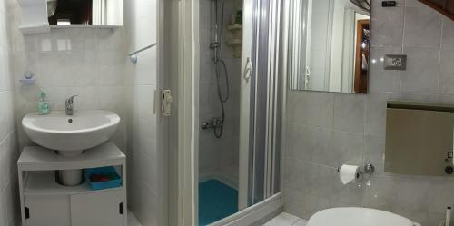 a bathroom with a shower and a sink and a toilet at Casa Reale in Gravina di Catania