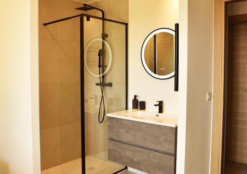 a bathroom with a shower and a sink and a mirror at La Villa d’Emma in Mougins