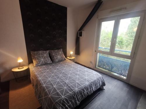 une chambre avec un lit et une grande fenêtre dans l'établissement Studio proche Tramway et Montpellier Business School, à Montpellier