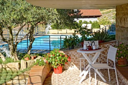a patio with a table and chairs and a pool at Gure Ametza in Obanos