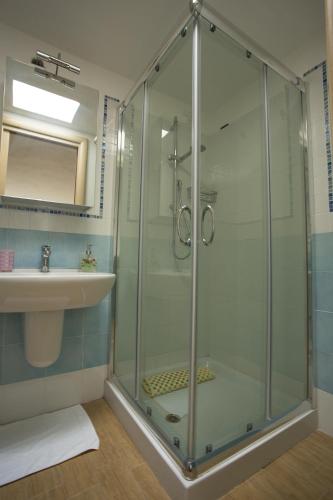 a bathroom with a glass shower and a sink at B&B Celestina Ischia in Ischia