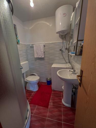 a small bathroom with a toilet and a sink at Edison in Jablanica