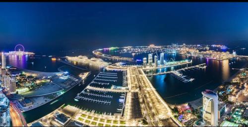 a night view of a harbor with boats in the water at Spectacular 2 bedroom Marina sea views in Dubai