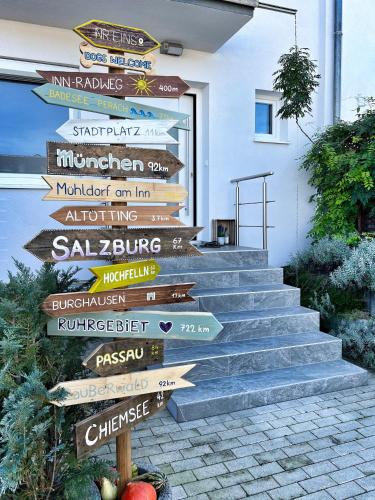 a bunch of directional signs on a staircase at NUMMER EiNS in Neuötting