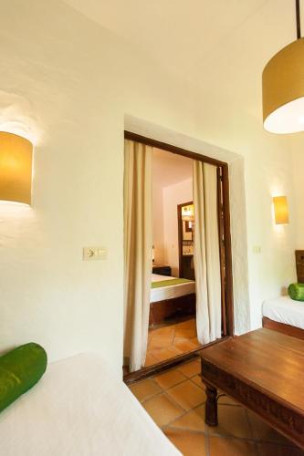 a living room with a bed and a mirror at 100% Fun in Tarifa