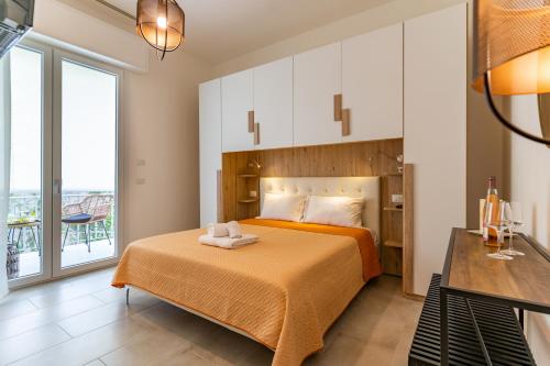 a bedroom with a bed and a large window at Doctor Guest House in Tortolì