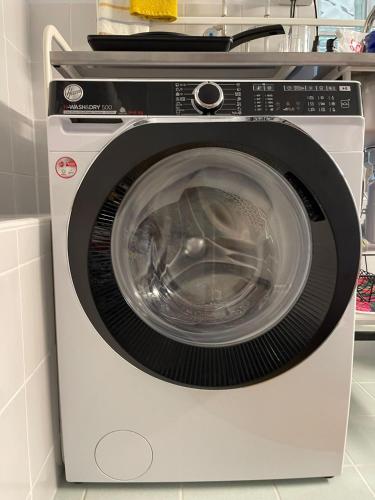 a white washing machine sitting in a kitchen at Sete Fontes - Agarone Holiday Nest in Agarone