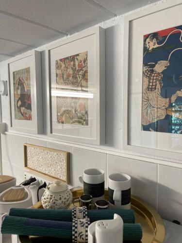a kitchen with a table with vases and paintings at Sete Fontes - Agarone Holiday Nest in Agarone