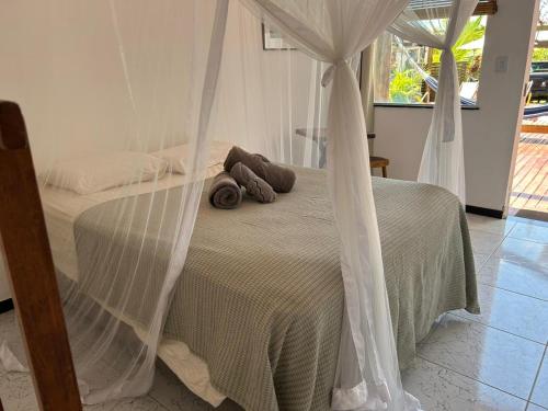 a bedroom with a bed with mosquito nets at Pousada Obedemar - Taipu de fora, Barra Grande, Ba in Barra Grande